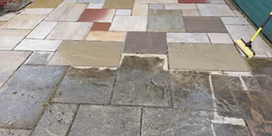 Patio pressure washing in Bristol with a visible clean section after jet washing